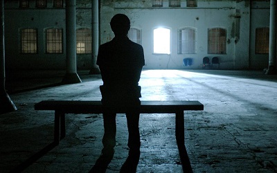 Photo of a boy sitting in the dark, taken from Andres Veiel's film \"The Kick\" 