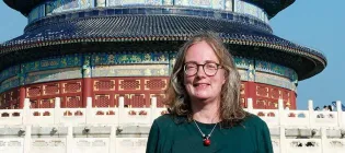 Photo of Esther standing at the foot of the steps to the Temple of Heaven in Beijing