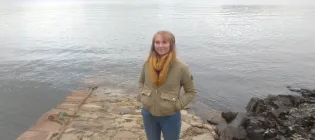 Isla Parker by a lake in the Scottish highlands
