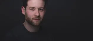 Head and shoulders photo of Laurie Motherwell against a black background