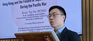 Photo of Tsz Ho at a lectern giving a presentation