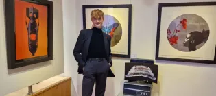 Man in front of a gallery wall