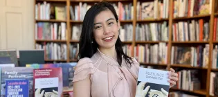 Photo of student holding a copy of her poetry pamphlet