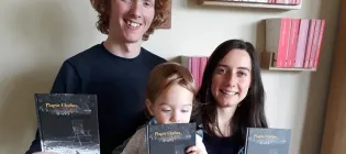 Photo of Taproot Press founders with books