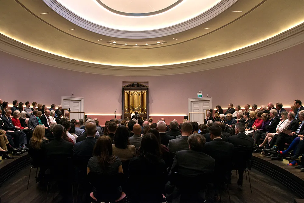 An audience enjoying a performance in the oval concert hall