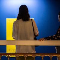 Photo of a visitor to Talbot Rice Gallery looking at one of the panels from the exhibition the nature of difference