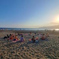 People on a beach doing yoga