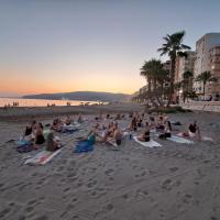 People on a beach doing yoga