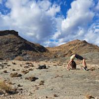 Anu Abicht doing yoga in a mountainous landscape