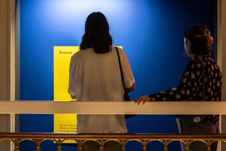 Photo of a visitor to Talbot Rice Gallery looking at one of the panels from the exhibition the nature of difference