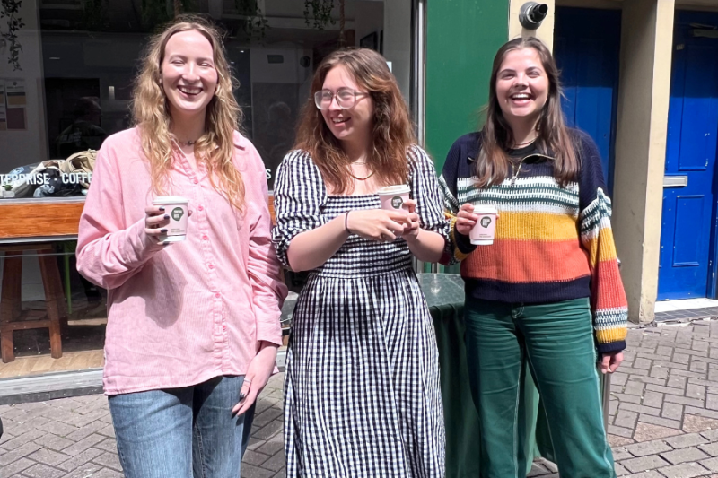 Three students in front of the Social Bite cafe in Edinburgh