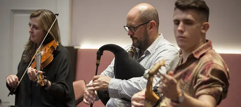 Photo of staff and students in a live music performance