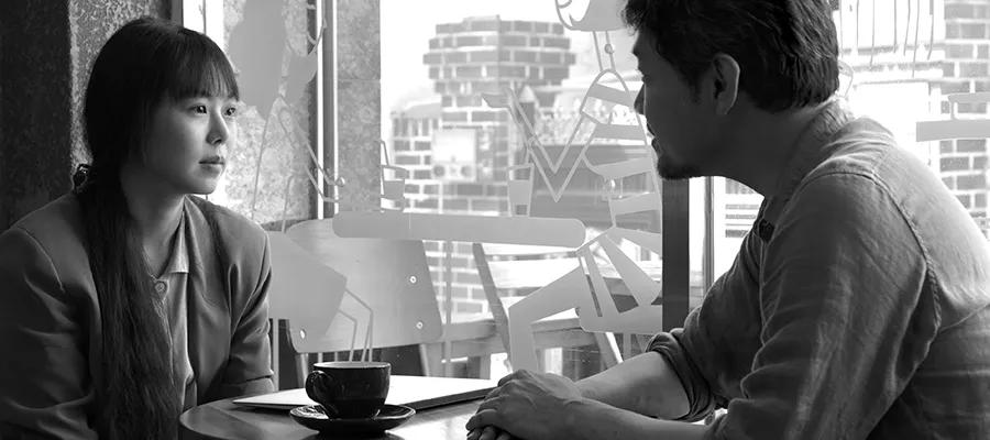 Sill from the film Grass of two people having coffee