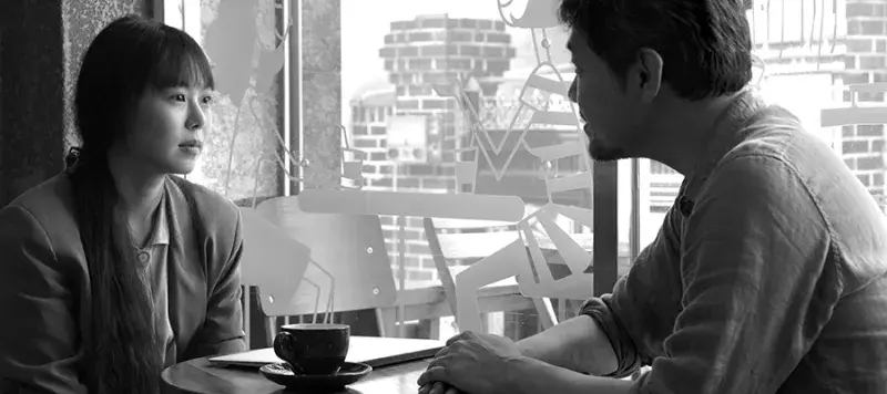 Sill from the film Grass of two people having coffee