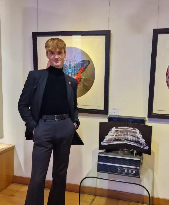 Man in front of gallery wall