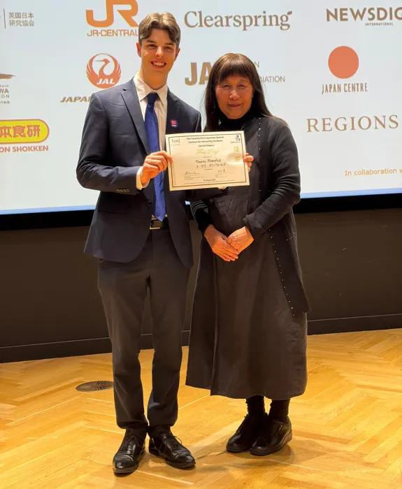 Photo of a student on the left and his mentor at the Japanese Speech Contest