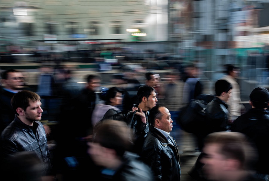 a blurry photo of people walking down a busy street