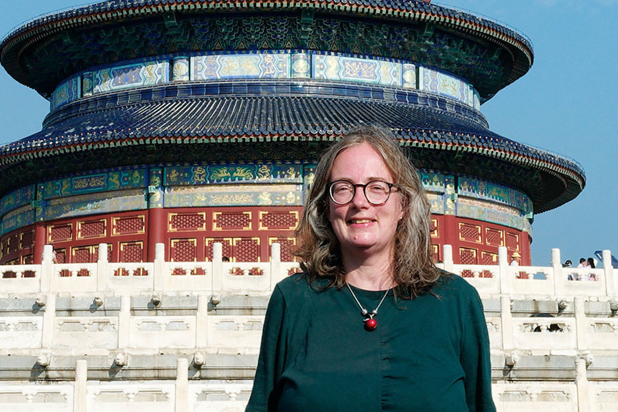 Photo of Esther standing at the foot of the steps to the Temple of Heaven in Beijing