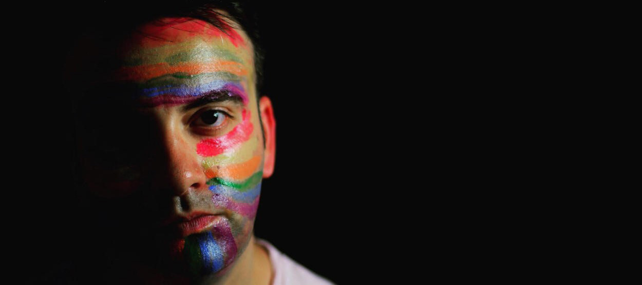 Photo of JD Stewart with a painted face against a black background