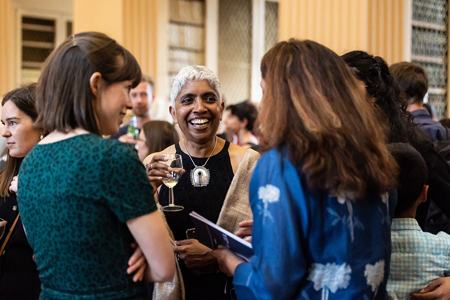 Photo of Hephzibah Israel chatting to guests at the opening of her exhibition