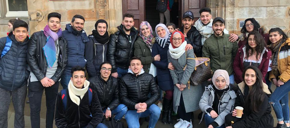 A group of people standing in front of a doorway